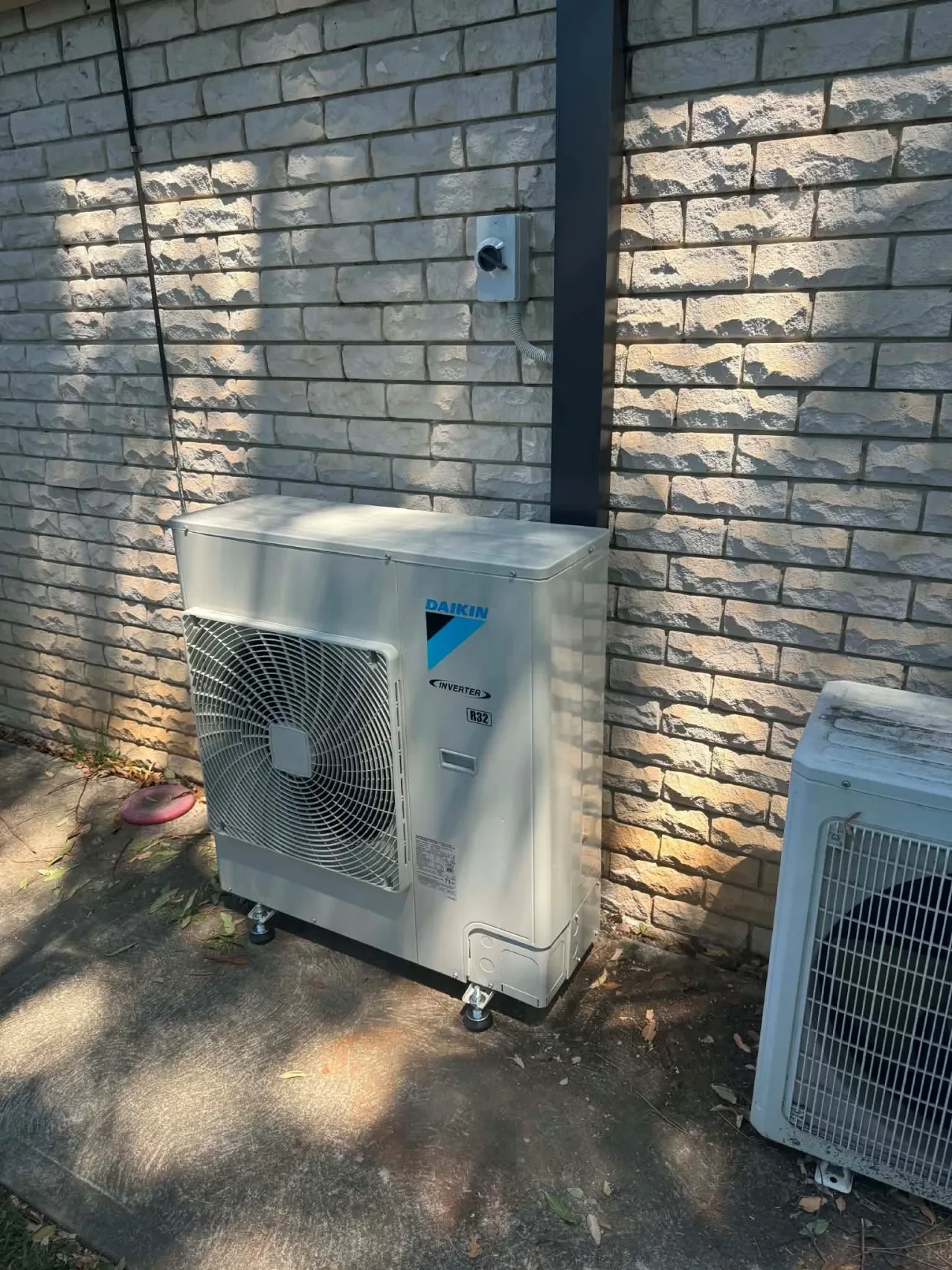 HVAC technician installing air conditioner